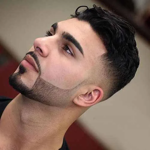 Tousled low fade haircut with beard