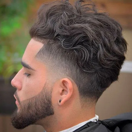 Wavy taper fade haircut with beard