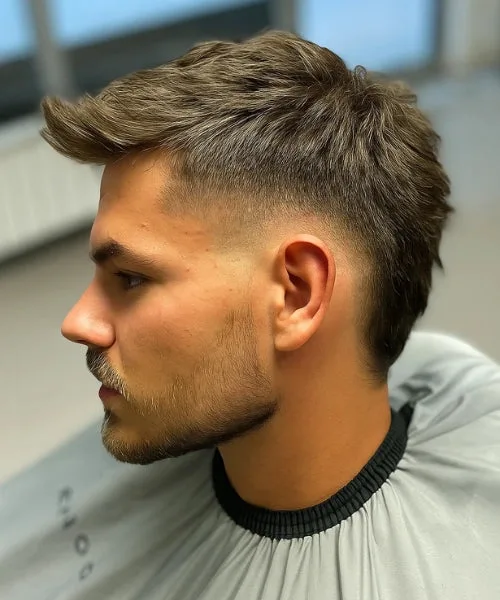 Burst fade Faux Hawk with arched taper and spiked crown for dramatic silhouette.