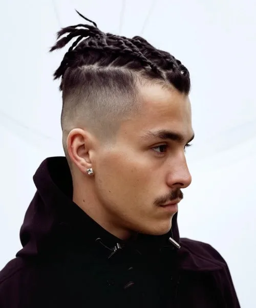 Faux Hawk with braided center and faded sides for high-impact textured style.