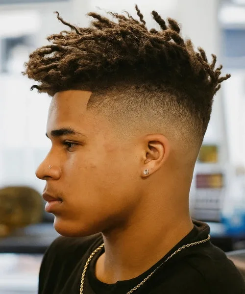 Faux Hawk with twisted dreads and tapered sides for bold, textured attitude.