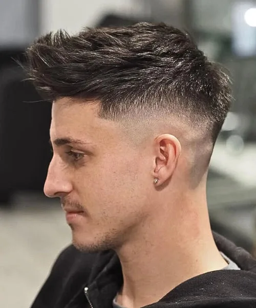 Faux Hawk quiff with brushed-back top and tapered sides for height and stylish movement.