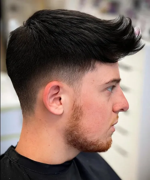 Faux Hawk with straight spiked top and faded sides for sleek definition and edge.