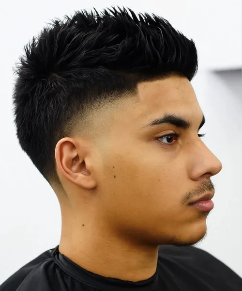 Faux Hawk with taper fade and spiked center for bold height and clean edge styling.