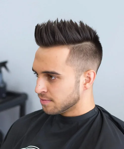 Faux Hawk with shaved sides and vertical spikes for rebellious, high-volume edge.