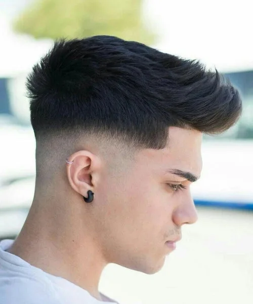 Low fade Faux Hawk with brushed-up crown and tight edges for sharp contrast and volume.