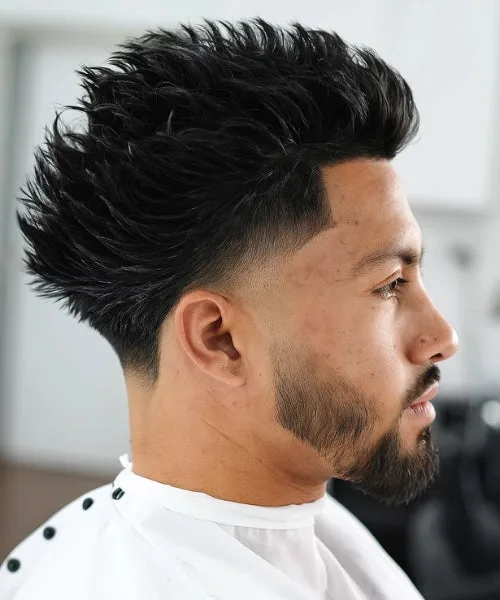 Low taper Faux Hawk with spiked top and sleek sides for balanced bold structure.