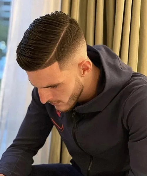 Modern side part hairstyle with sleek division, polished top, and trendy structured flow.