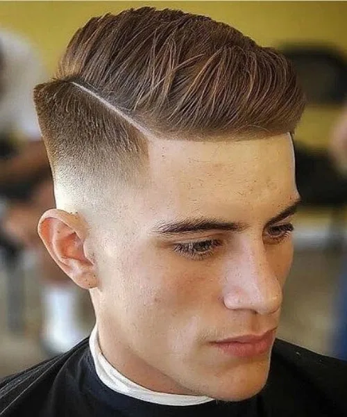 Side part fade haircut with clean taper and voluminous top styled for sharp modern finish.