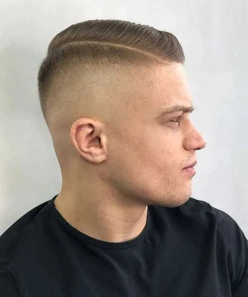 Side part high fade haircut with bold contrast, neat taper, and voluminous parted top.