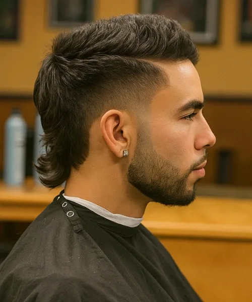Side part mullet haircut with structured top, clean part, and textured length at back.