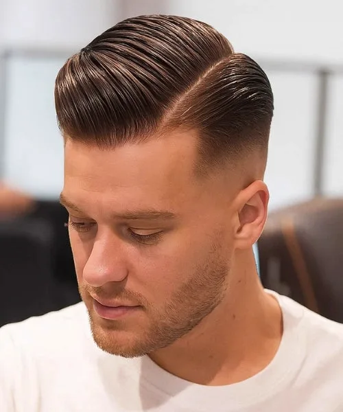 Side part slick back hairstyle with defined part, brushed-back top, and smooth polished flow.