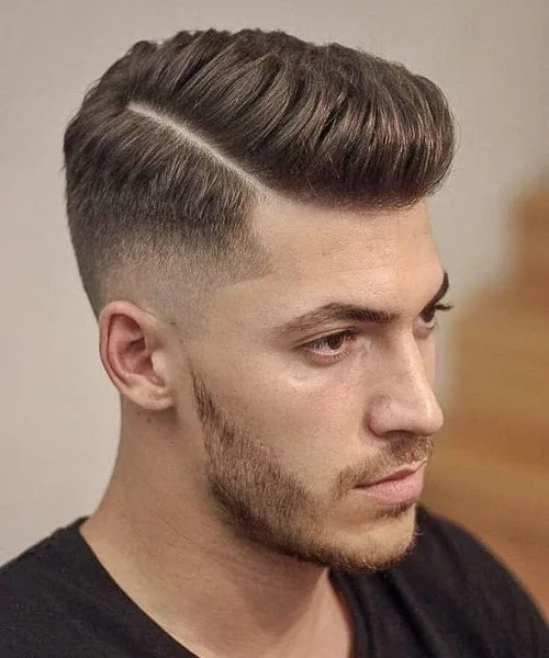 Side part taper haircut with gradual fade on sides and voluminous top styled neatly.