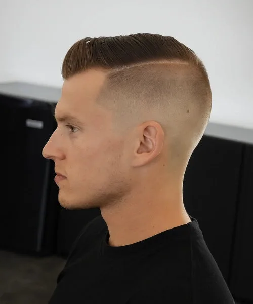 Side part undercut hairstyle with sharp faded sides and voluminous parted top for contrast.