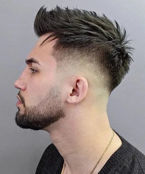Skin fade Faux Hawk with spiky top and clean bald fade for edgy, high-contrast texture.
