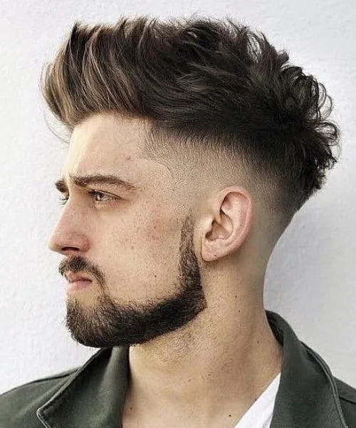 Textured Faux Hawk with messy layers and skin taper for explosive volume and lift.