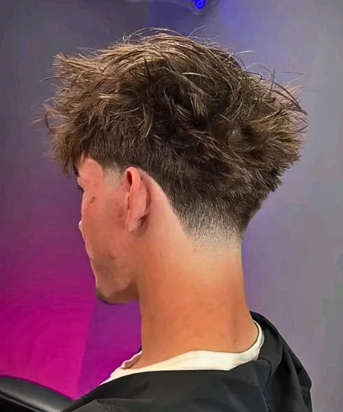 Blowout temple fade with high volume textured top and clean faded sides for bold style.