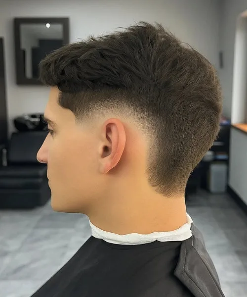 Burst temple fade haircut with rounded fade around ears and textured top for bold contrast.