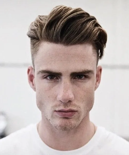 Long hair comb over with voluminous brushed top and neatly faded sides for stylish balance