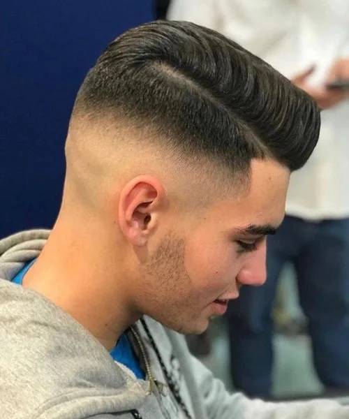 Comb over mid fade haircut with balanced faded sides and sleek top for a modern polished look