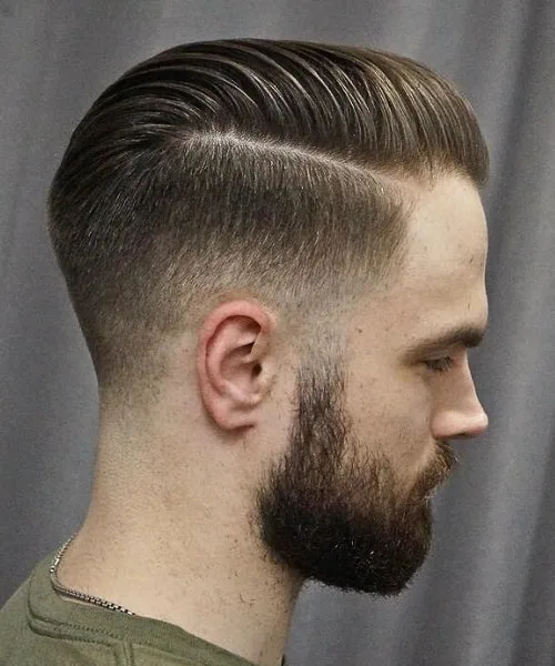 Slick back comb over haircut with polished brushed top and tapered faded sides for trendy style