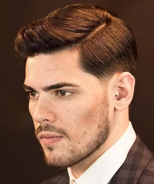 Comb over temple fade with sharp sides and textured top for clean, modern men’s style.