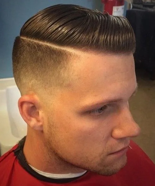 Comb over undercut haircut with sharp contrast sides and sleek, structured top for bold style