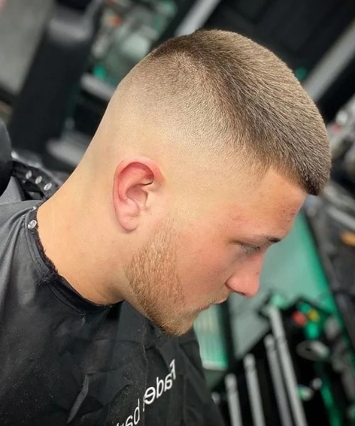 High skin fade haircut with bold contrast and short top for a sharp, modern edge