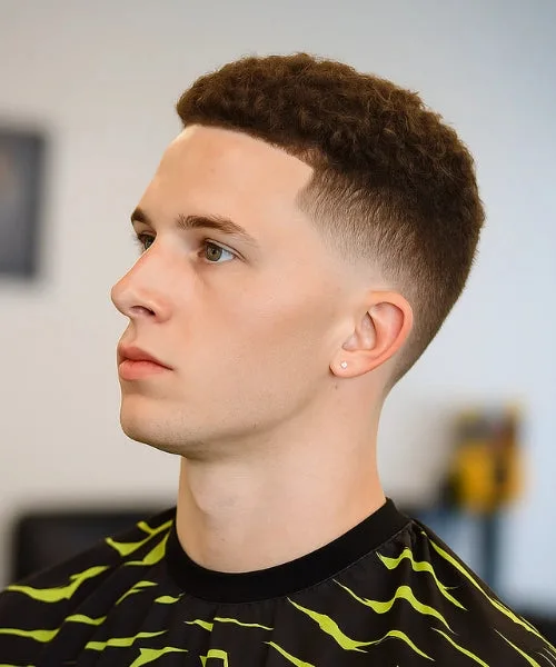 High temp fade with sharp temple taper and bold contrast for clean, edgy men’s haircut.