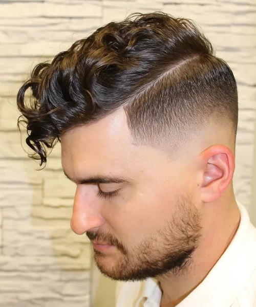 Messy comb over haircut with textured brushed top and faded sides for a casual stylish vibe