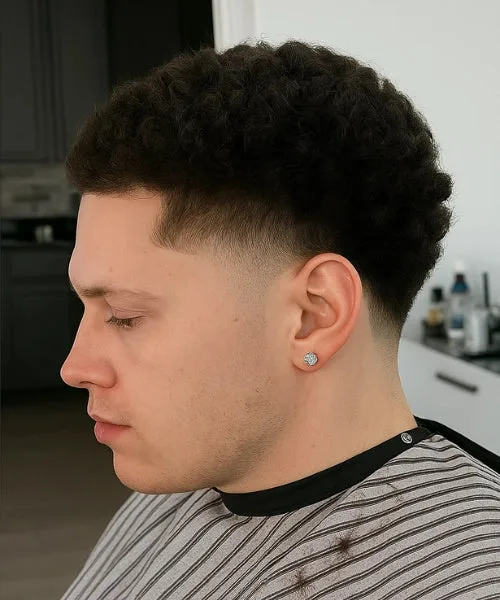 Mid temp fade haircut with smooth temple blend and lifted textured top for modern style.