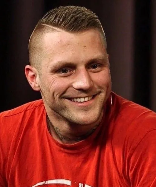 Military comb over fade haircut with high fade sides and neatly structured top for disciplined look