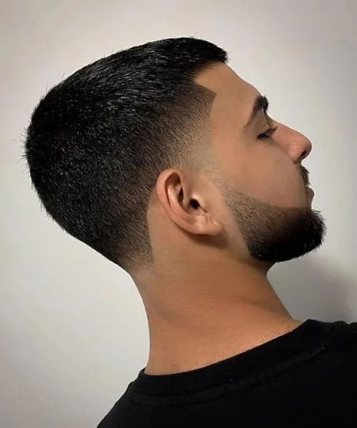 Short temple fade haircut with neat faded edges and minimal textured top for sleek finish.