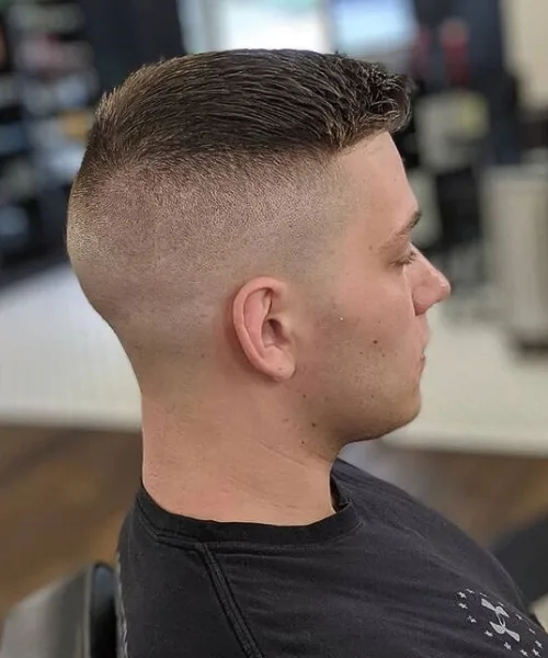 Bald skin fade haircut with skin-level sides and short neat top for bold contrast
