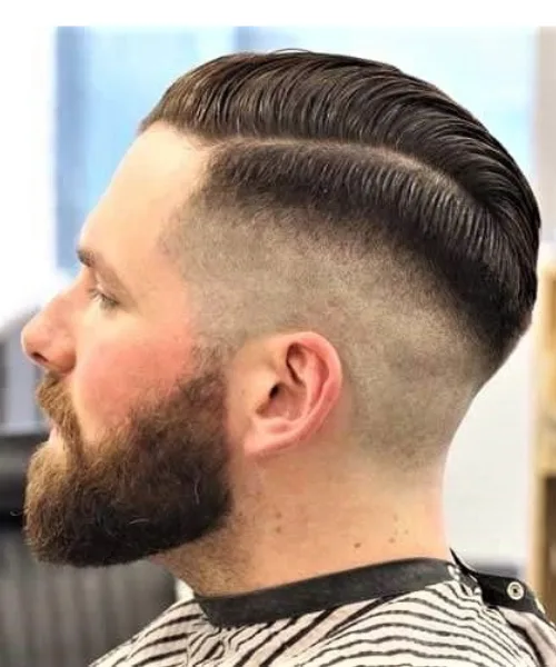 Skin fade with beard style blending sharp fade into full beard for masculine definition