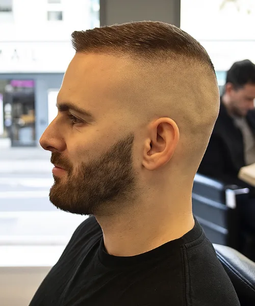 Skin fade crew cut with cropped textured top and faded sides for a clean, masculine look