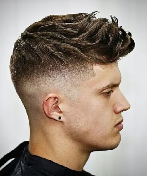 Skin fade faux hawk haircut with edgy spiked top and sharp faded sides for bold style