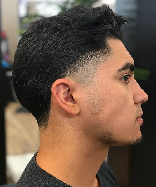 Mid taper skin fade with balanced sides and textured volume on top for a youthful look
