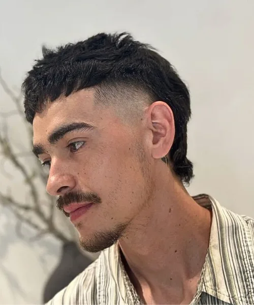 Skin fade mullet with faded sides and longer textured back for retro-meets-modern style