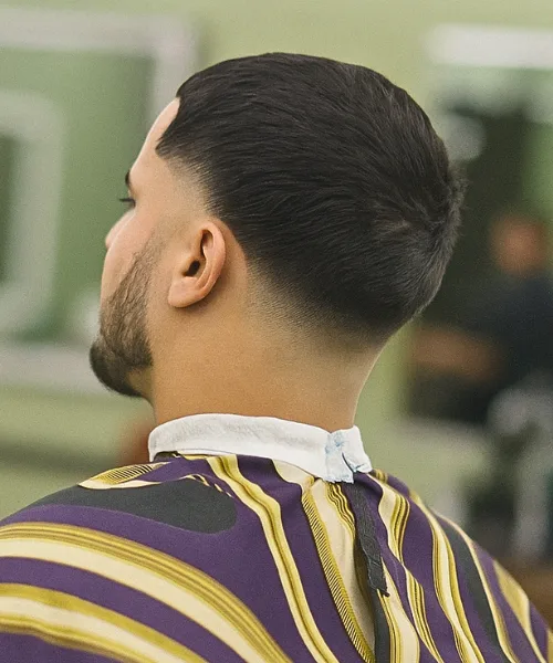 Taper skin fade haircut with gradual faded sides and textured top for versatile styling