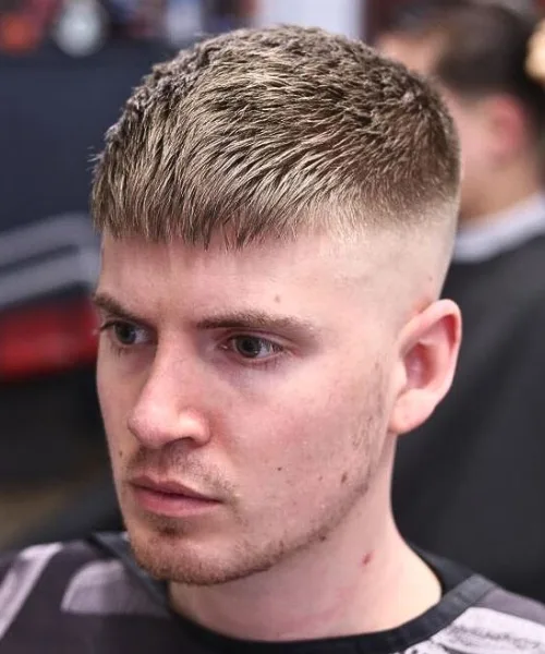 Skin fade textured fringe haircut with faded sides and choppy layered fringe on top