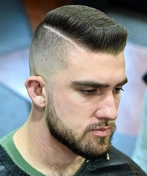 Skin fade undercut haircut with sharp faded sides and longer textured top for contrast