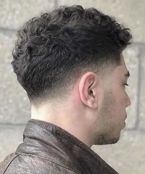 Taper temple fade haircut with gradual fade and defined textured top for classic polish.