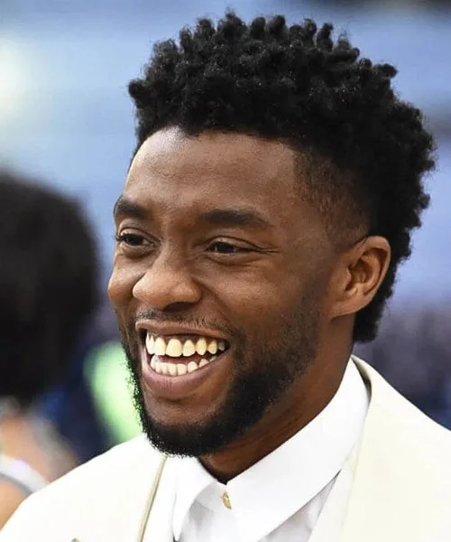 Temple fade afro with tight curls and sharp faded temples for stylish, defined look.