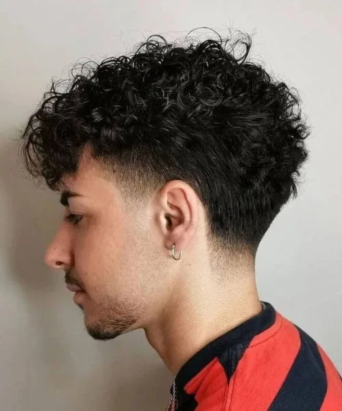 Temple fade curly hair with defined curls and clean edges for fresh, modern contrast.