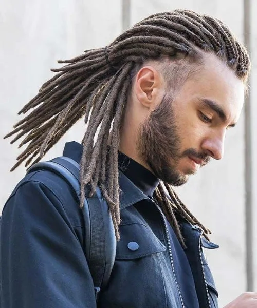Temple fade dreads with clean faded temples and smooth, defined dreadlocks on top.