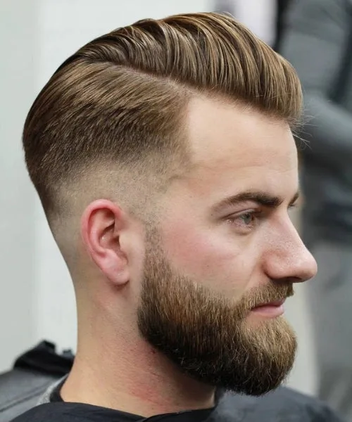 Textured comb over haircut with layered volume on top and sharp fade for modern dimension