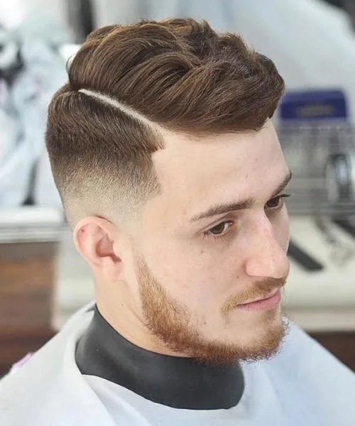 Wavy comb over haircut with natural textured waves on top and clean faded sides for stylish contrast