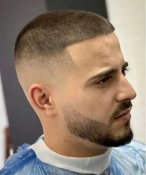 Caesar buzz cut with cropped fringe, evenly trimmed top, and faded sides for a clean profile