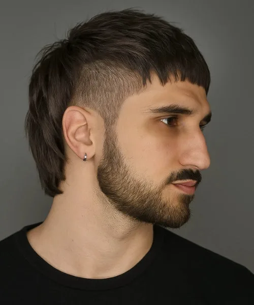 Caesar mullet haircut with short blunt fringe, faded sides, and extended layered back